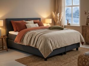 Complete boxspring bed met antraciet gestoffeerd frame en warme dekbedden in gezellige slaapkamer met winterse sfeer